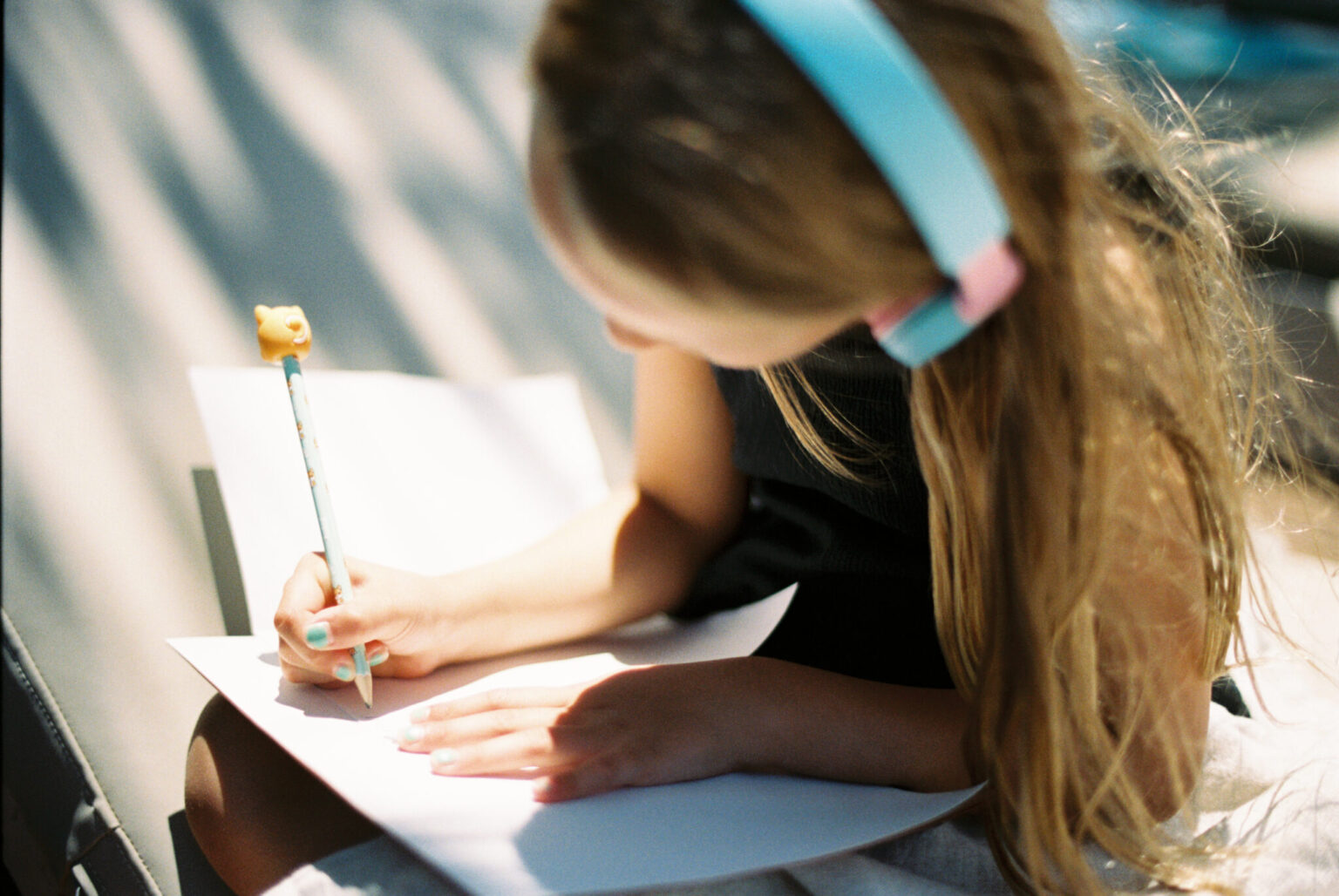 a girl writing on a piece of paper
