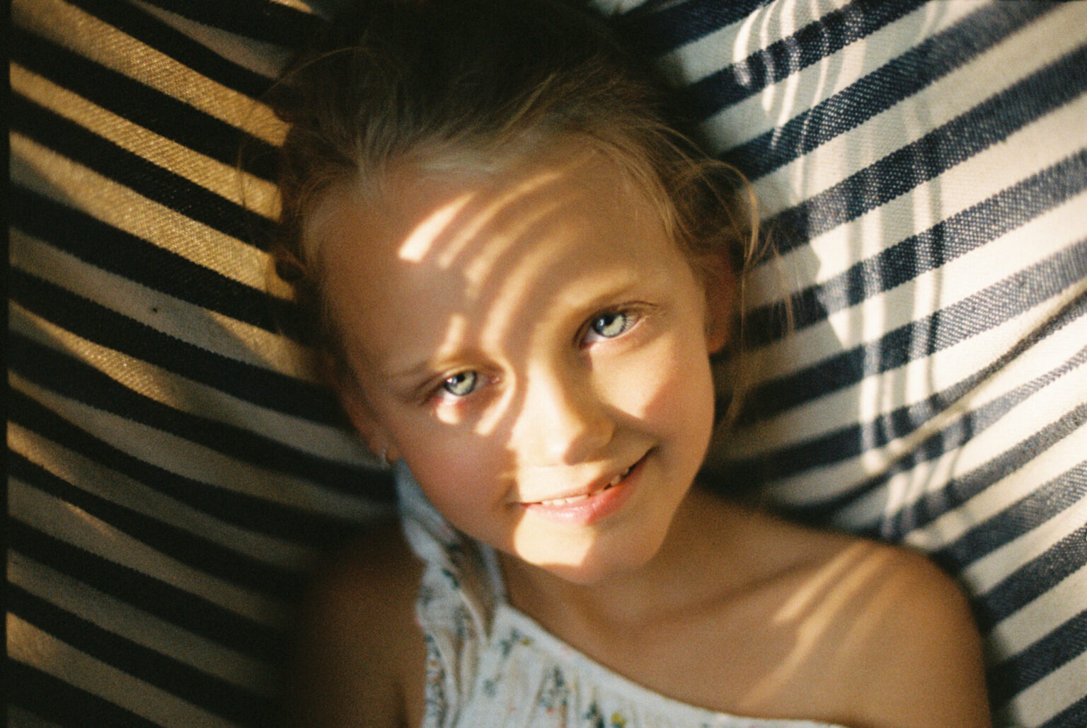 a girl lying on a striped surface