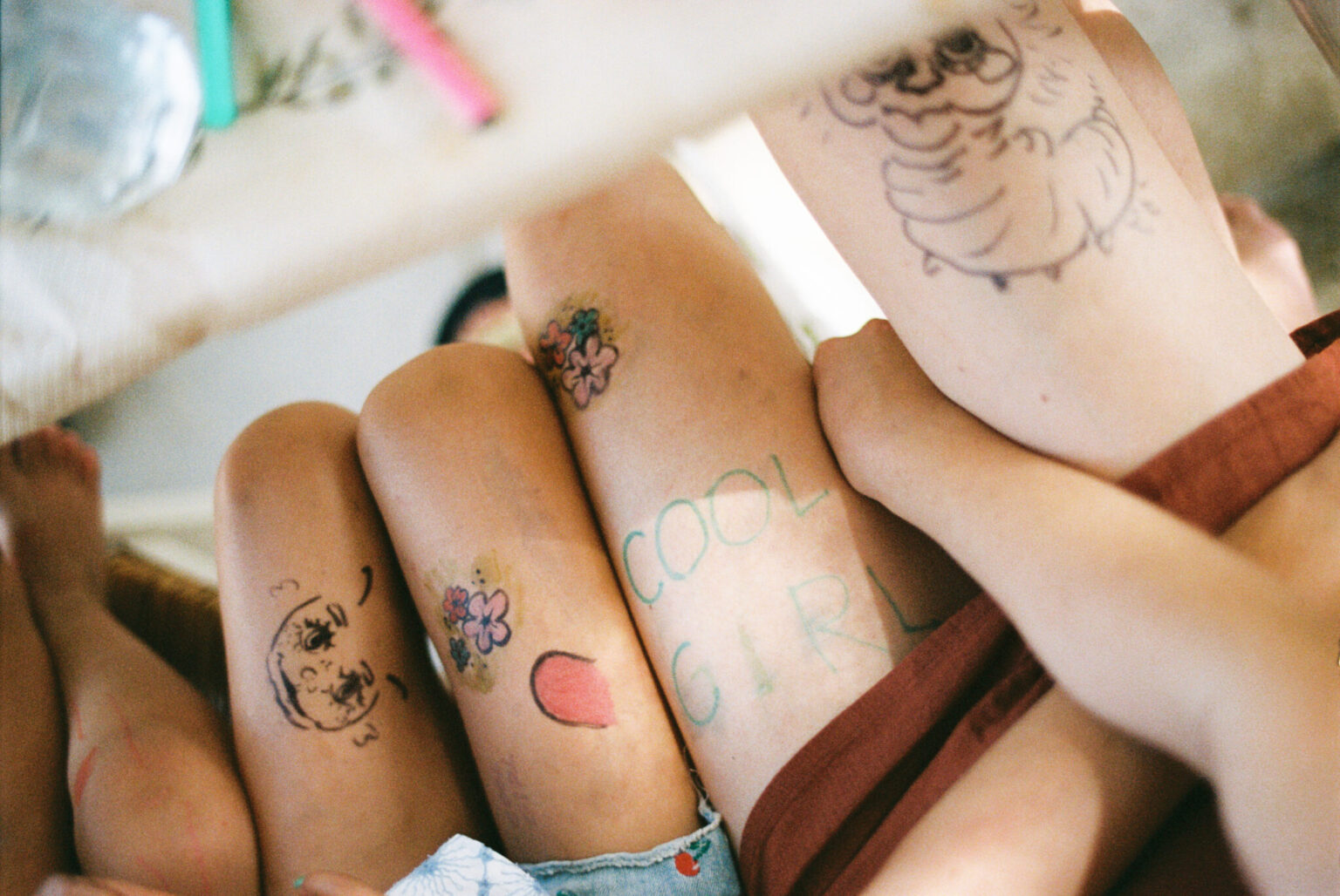 a group of people with tattoos on their legs