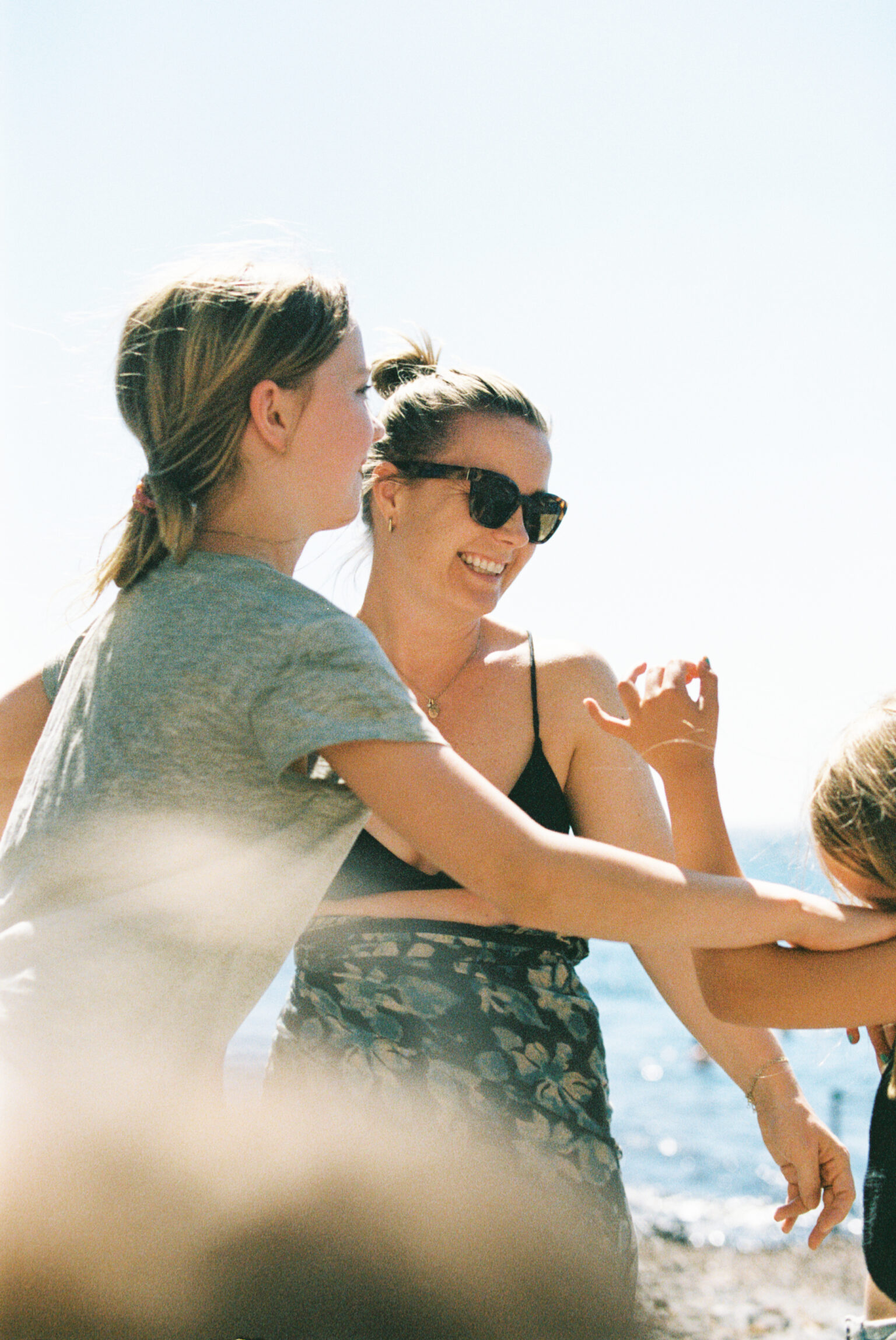 a group of women standing on a beach