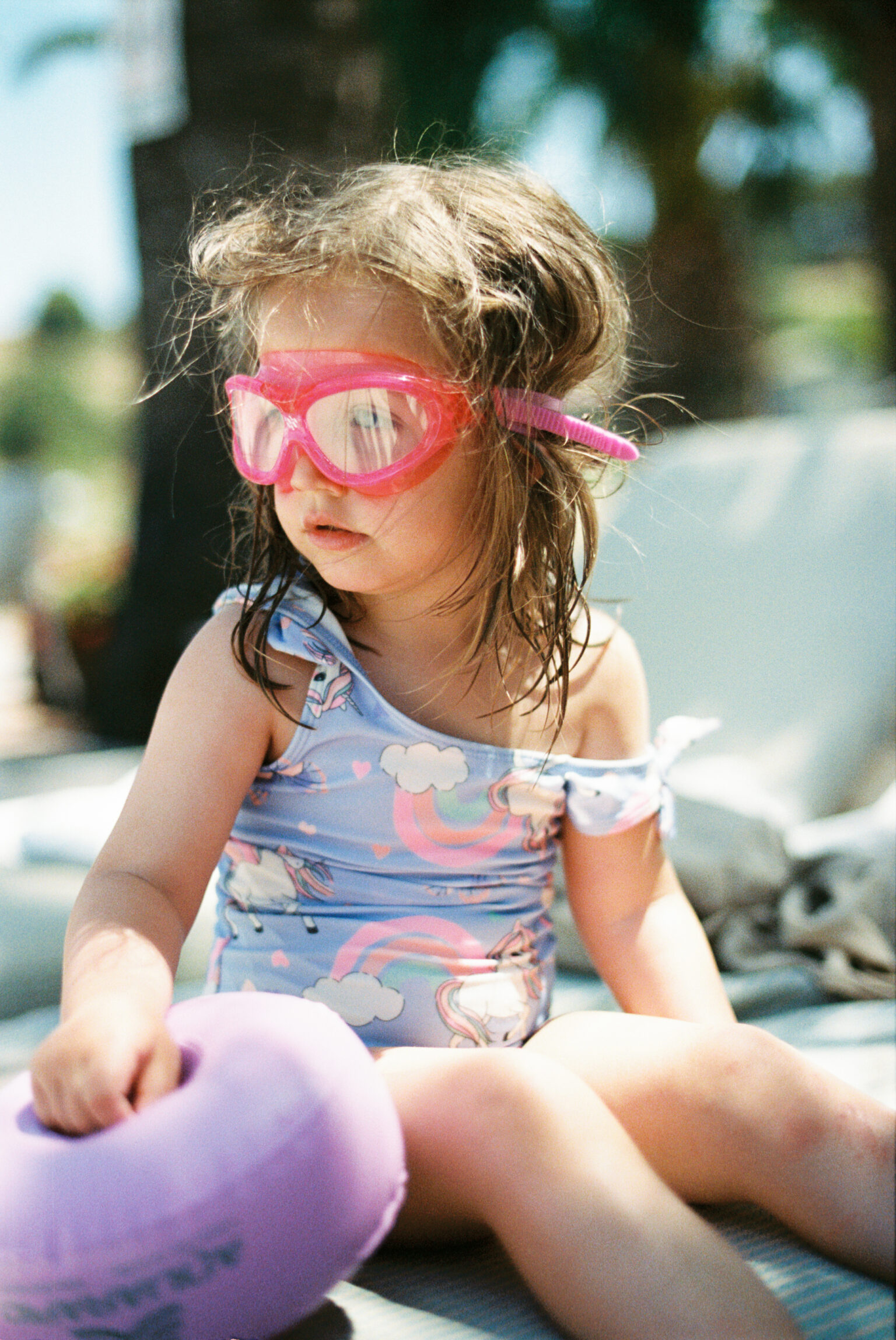 a girl wearing pink goggles