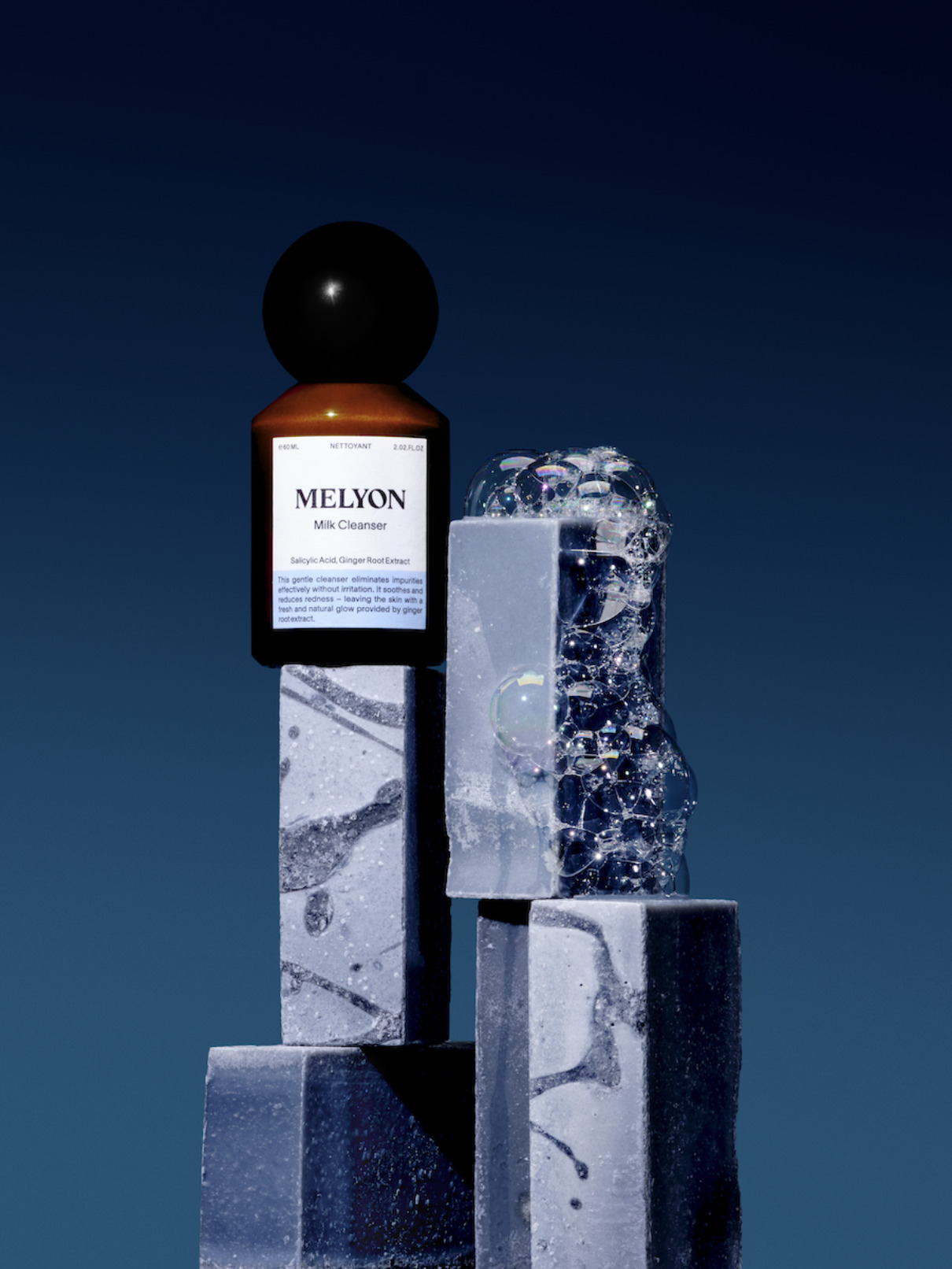 a bottle of milk cleaner on top of a stack of marble blocks