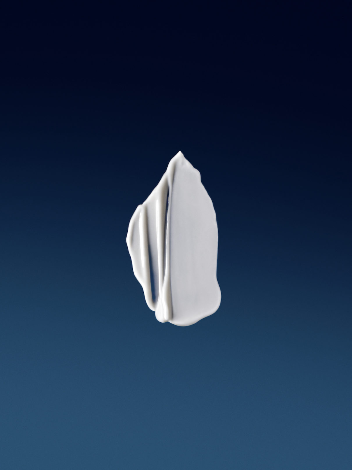 a white liquid on a blue background