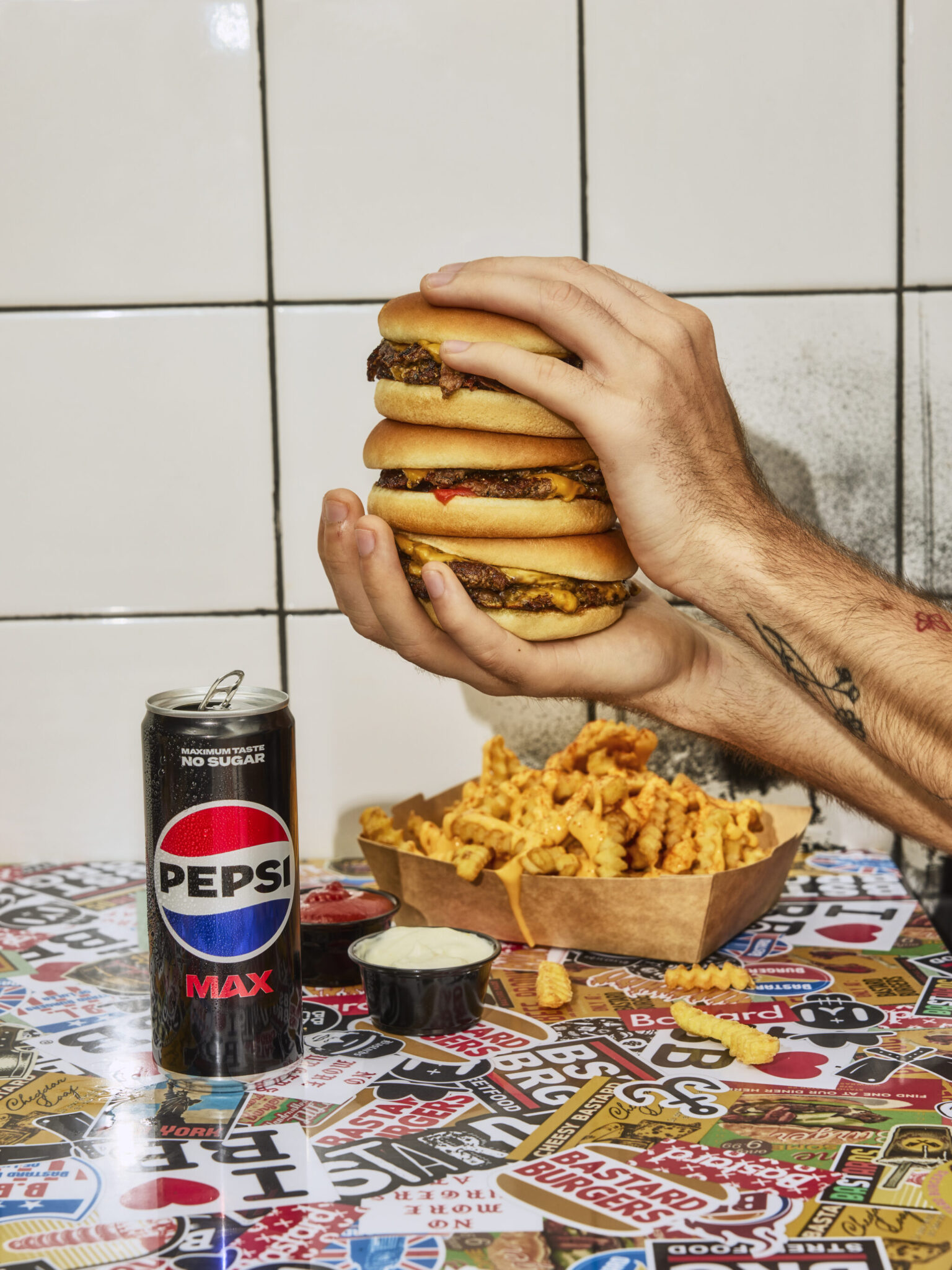 a person holding a stack of hamburgers