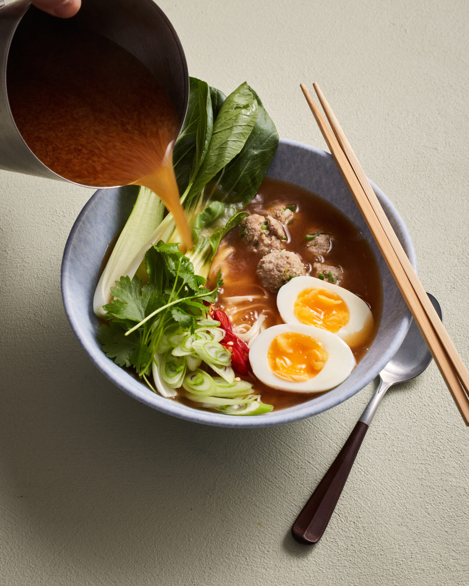 a bowl of soup with vegetables and meat