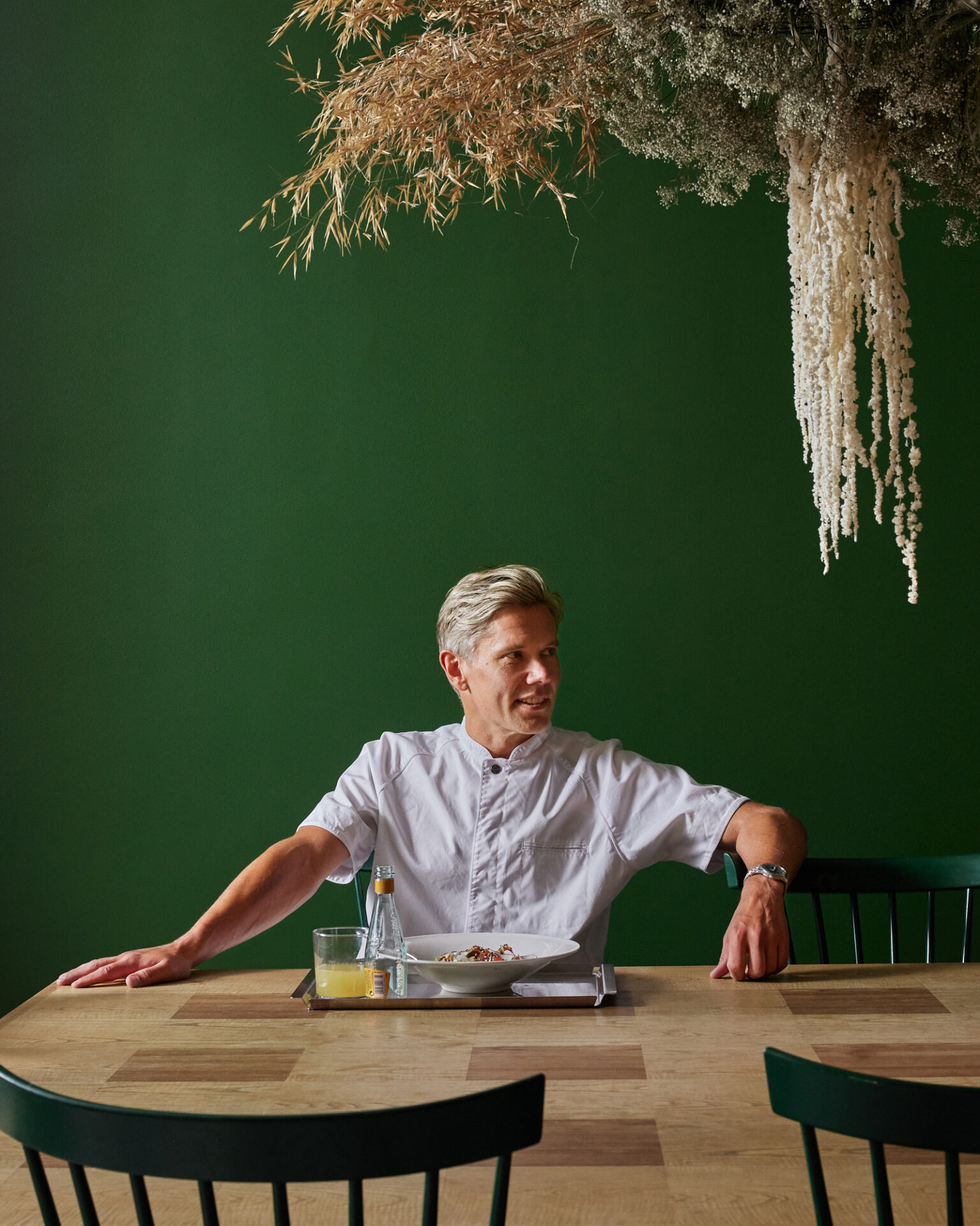 a man sitting at a table with a plate of food