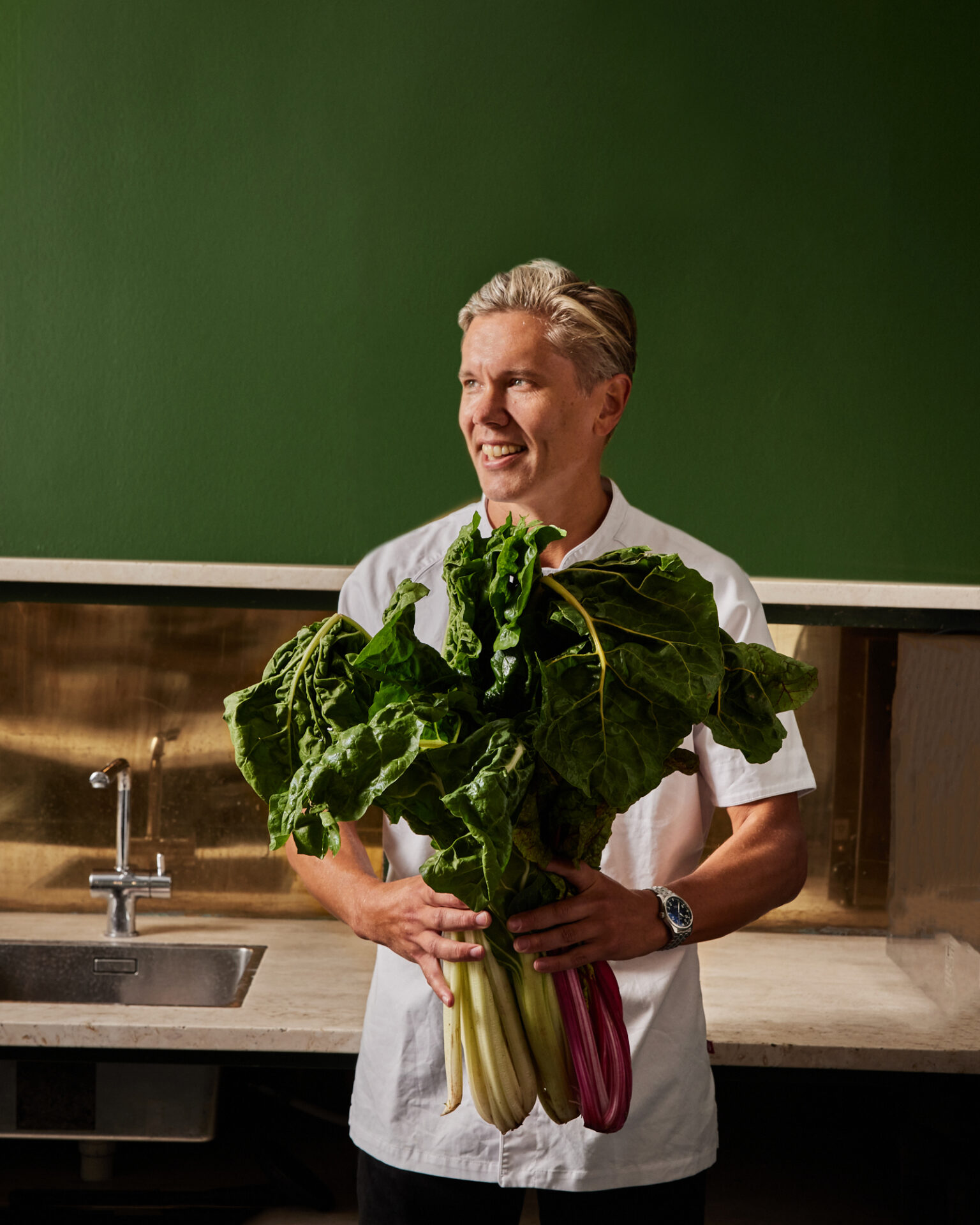 a man holding a bunch of vegetables