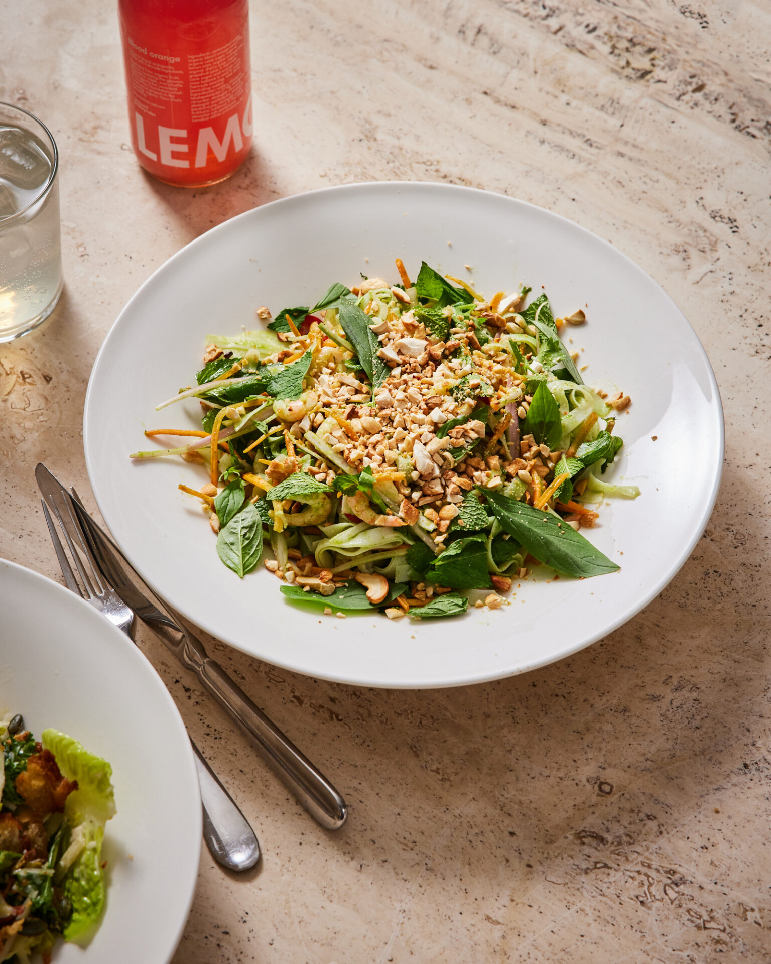 a plate of salad with nuts and herbs