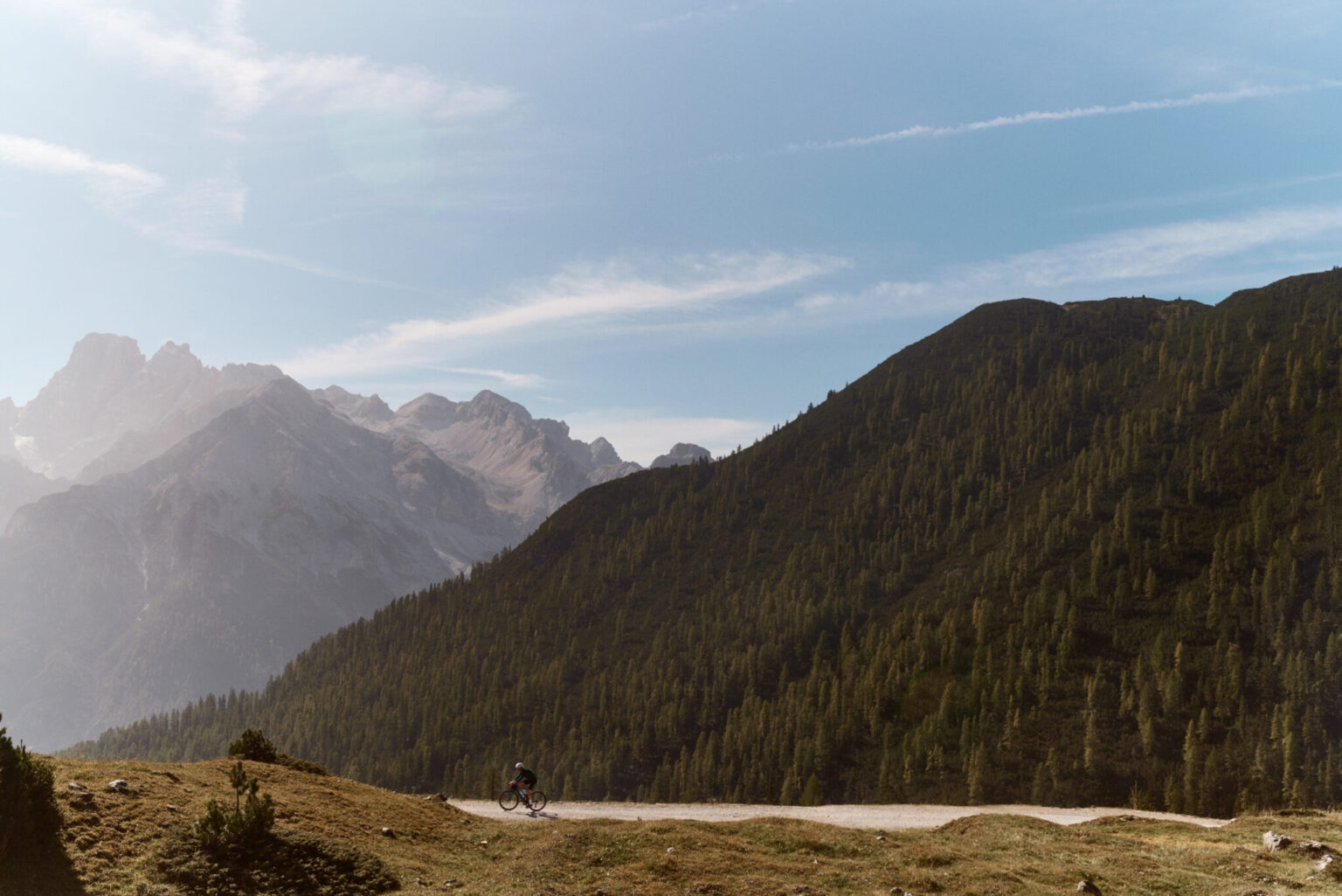 a person riding a bicycle on a mountain road