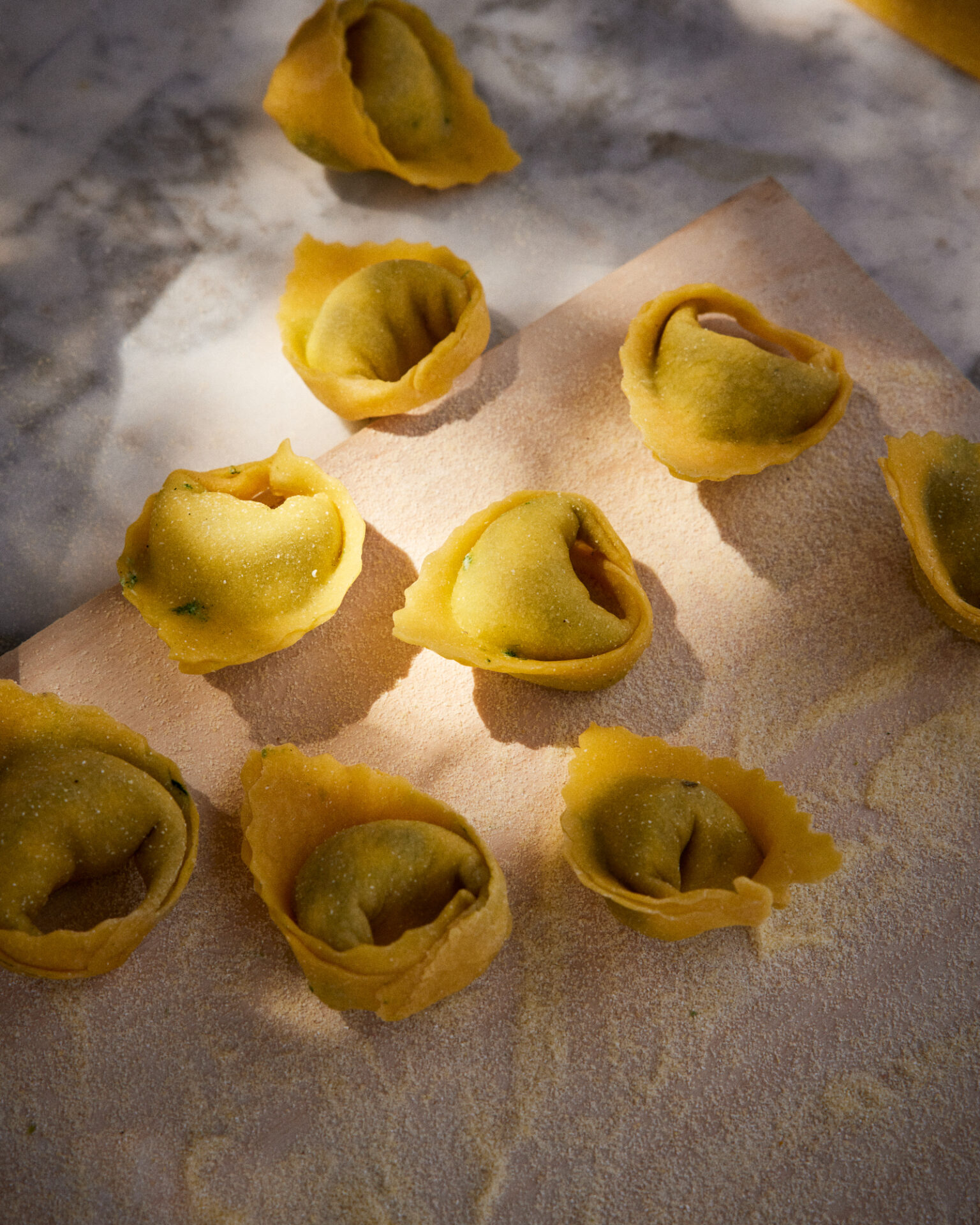 a group of tortellini on a cutting board