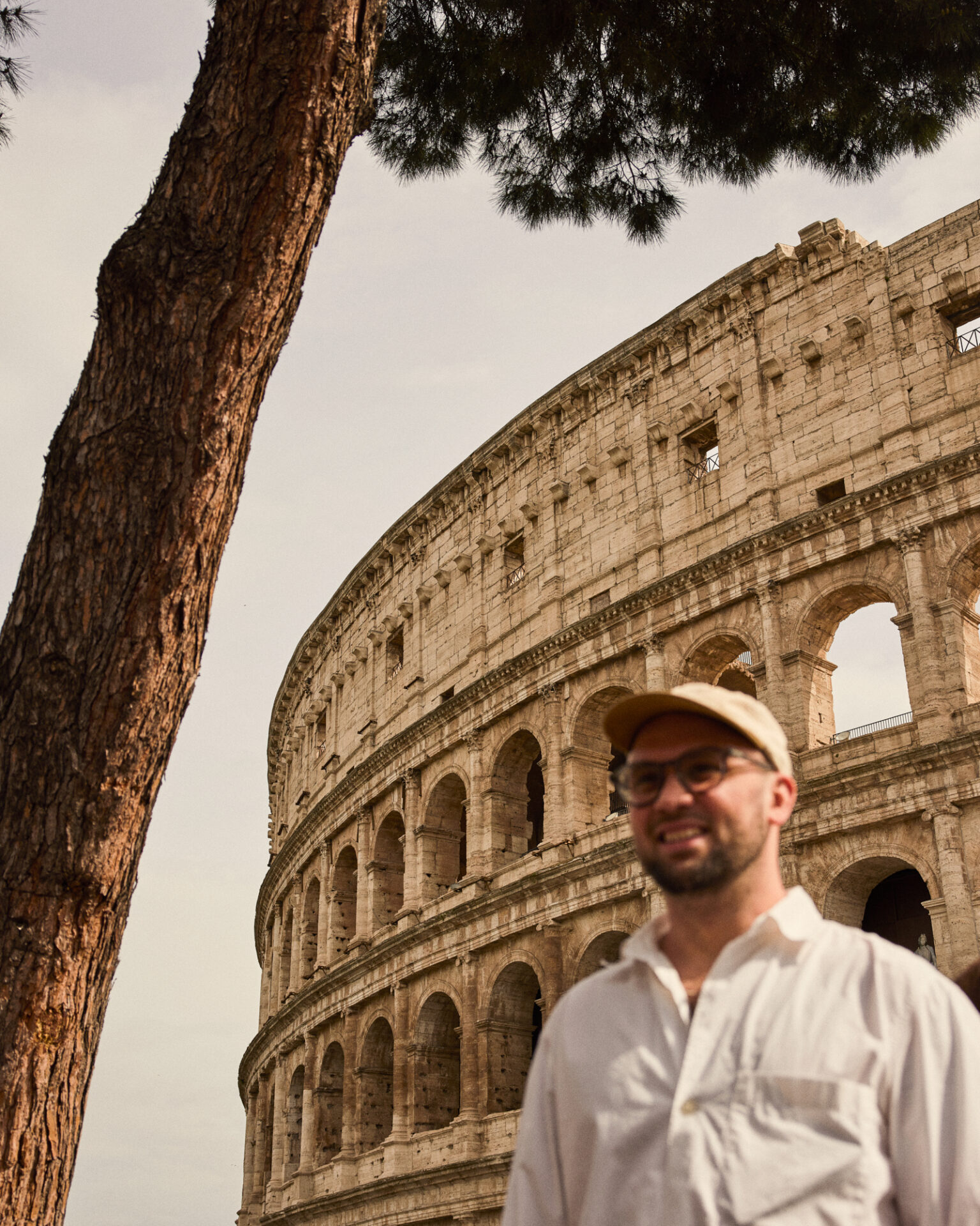 a man standing in front of a large stone building