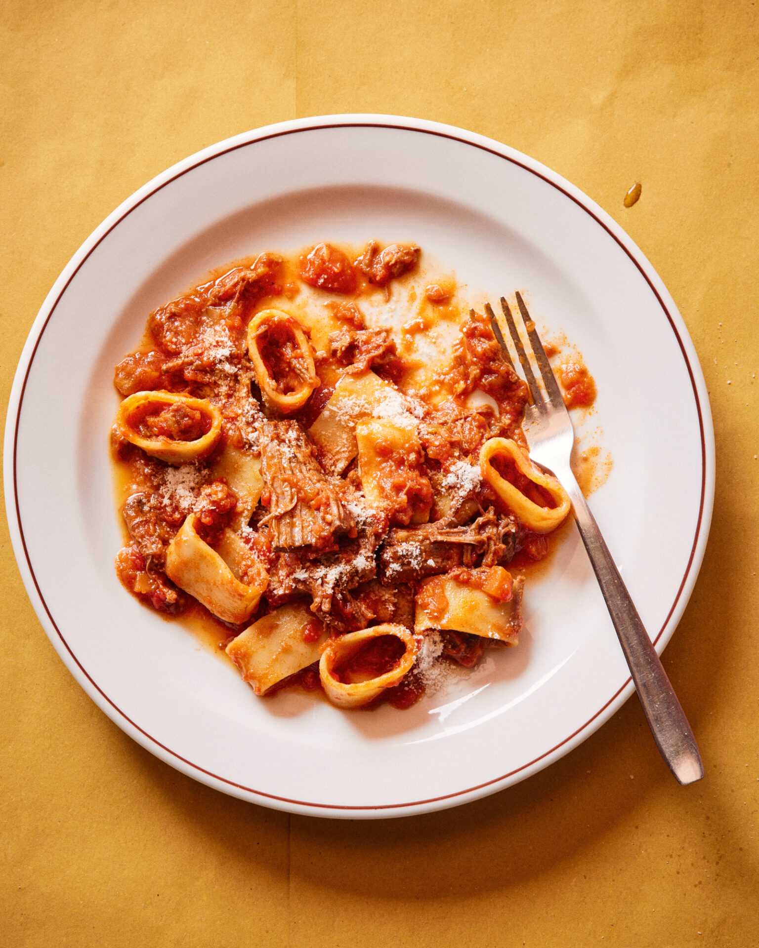 a plate of pasta with meat and cheese on it