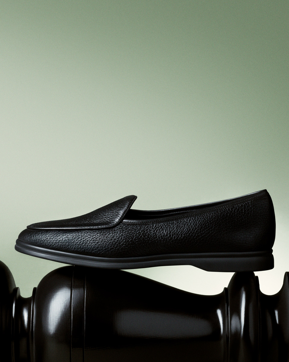 a black loafer on a chess piece