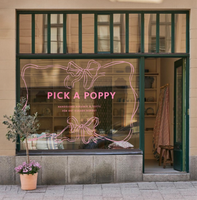 Shop window with pink bow graphic and "PICK A POPPY" text.