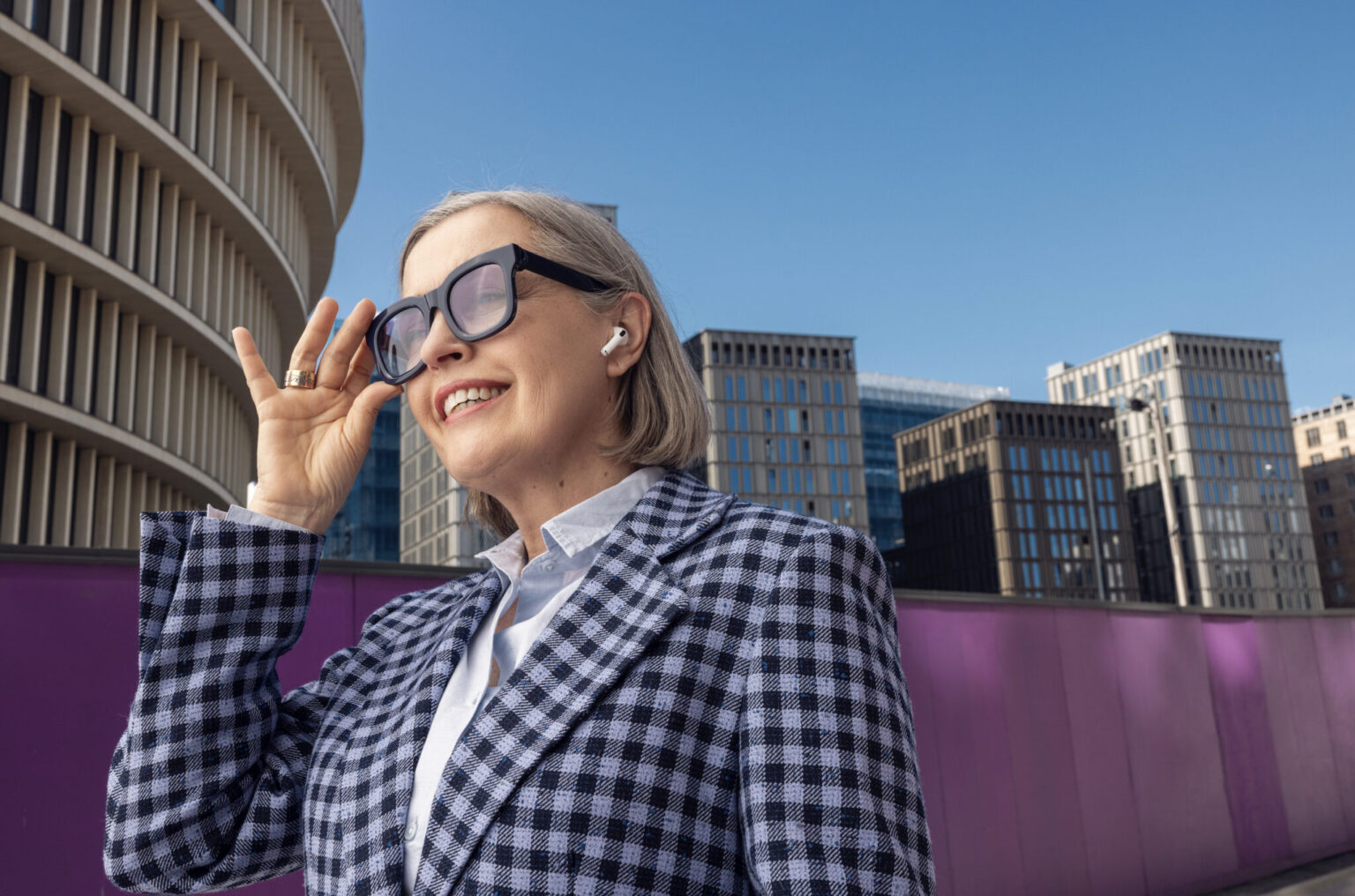 a woman wearing glasses and smiling