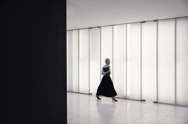 a woman walking in a hallway