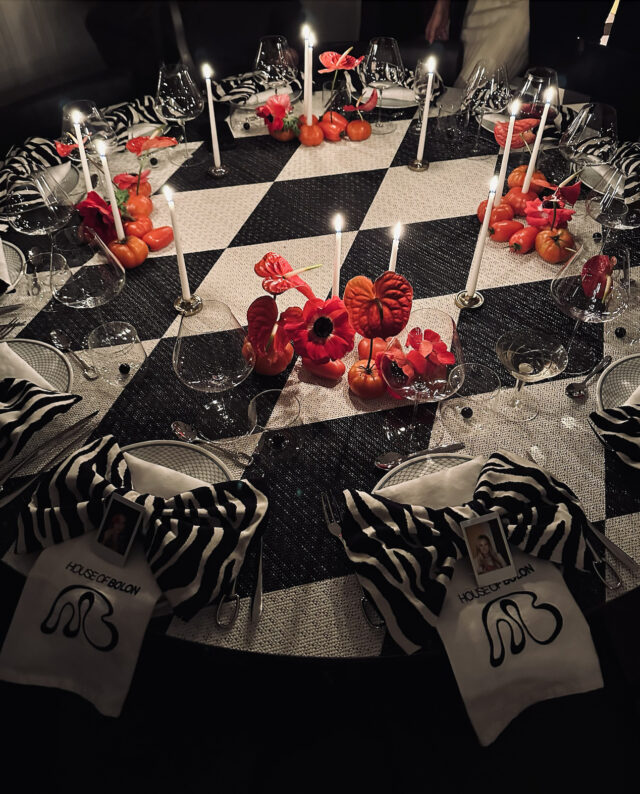 a table with glasses and candles