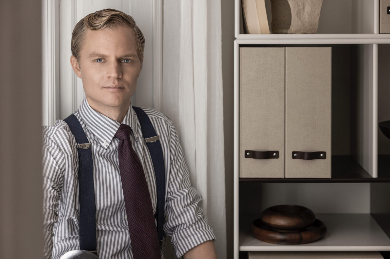 a man in suspenders and tie