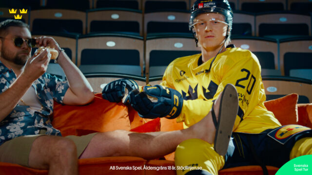 a man wearing a helmet and gloves sitting on a chair