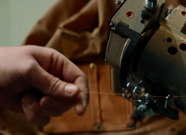 a person sewing a thread