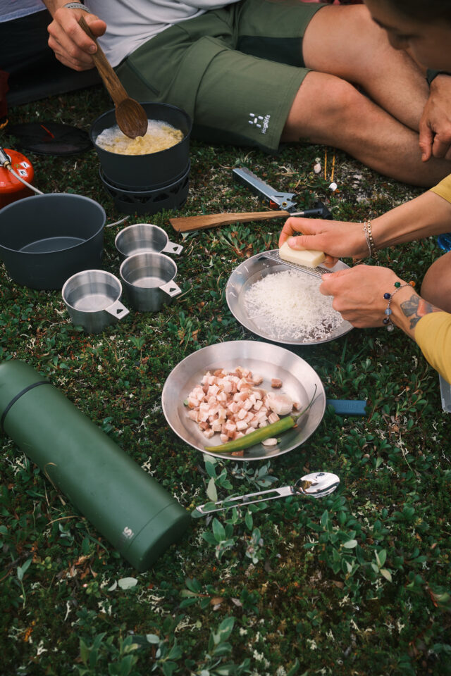 a person cooking food on the grass