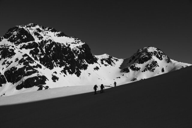 a group of people on skis on a snowy mountain