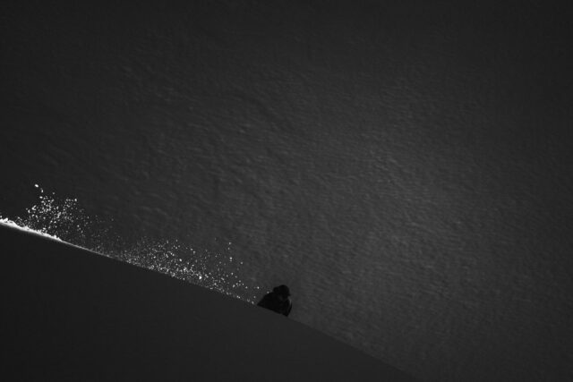 a person standing on a snowy hill