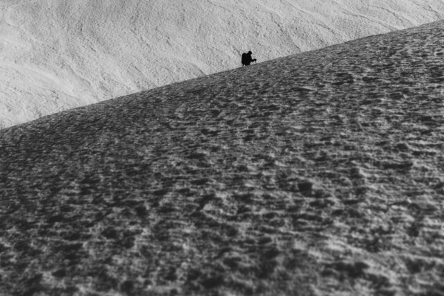 a person walking on a snowy hill