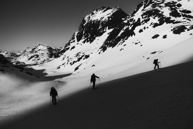 a group of people skiing down a snowy mountain