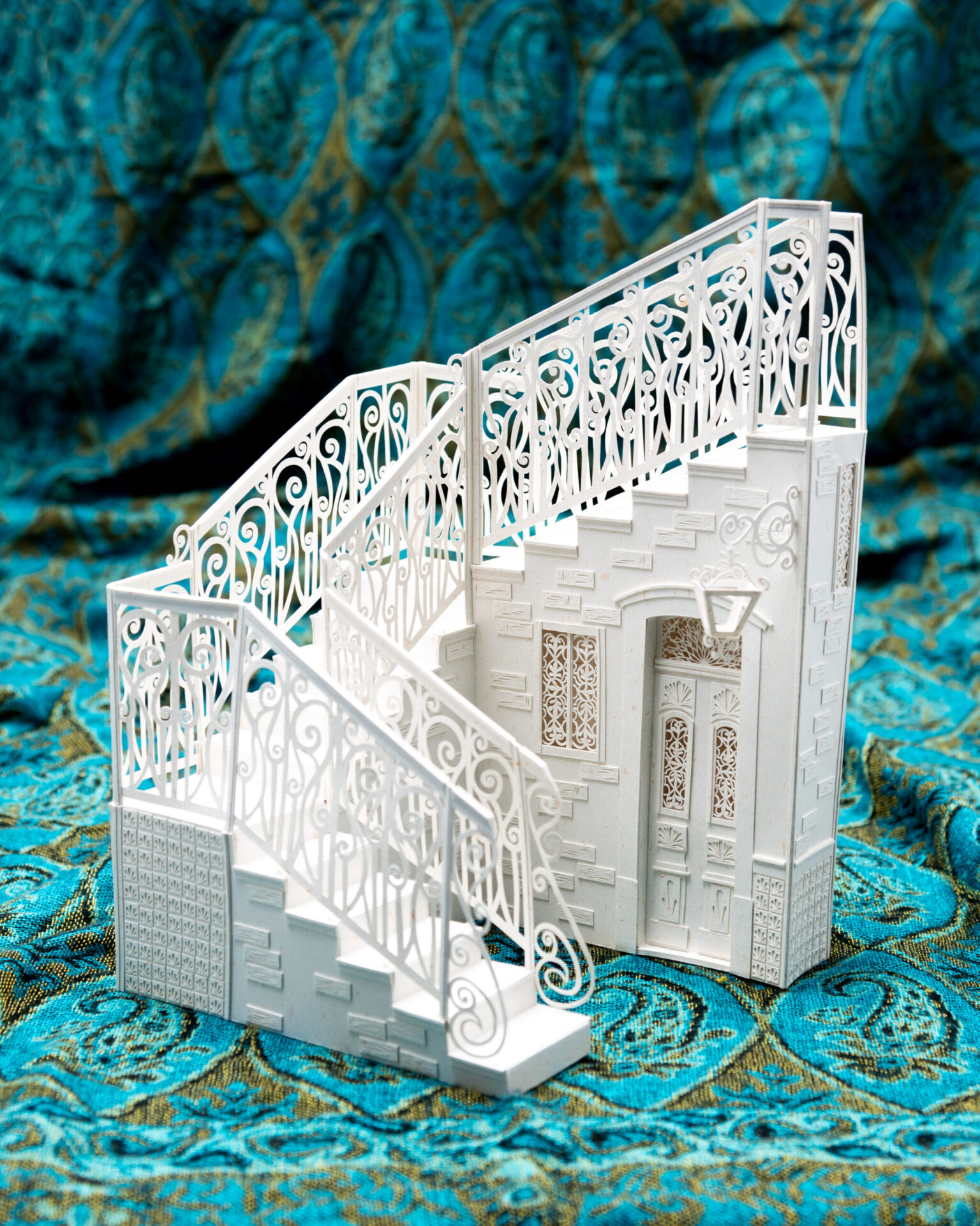 a white model of a house with a staircase