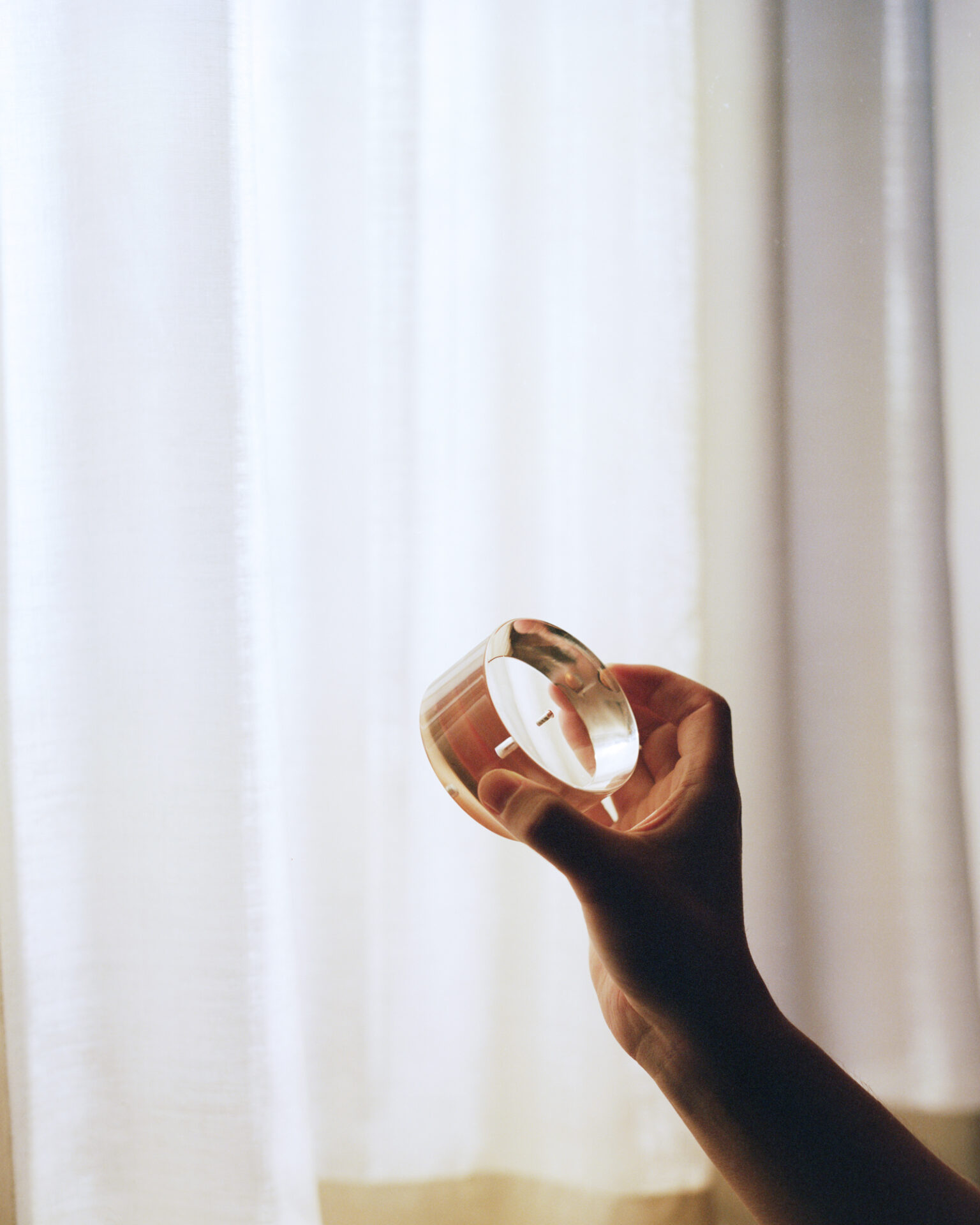 a hand holding a candle