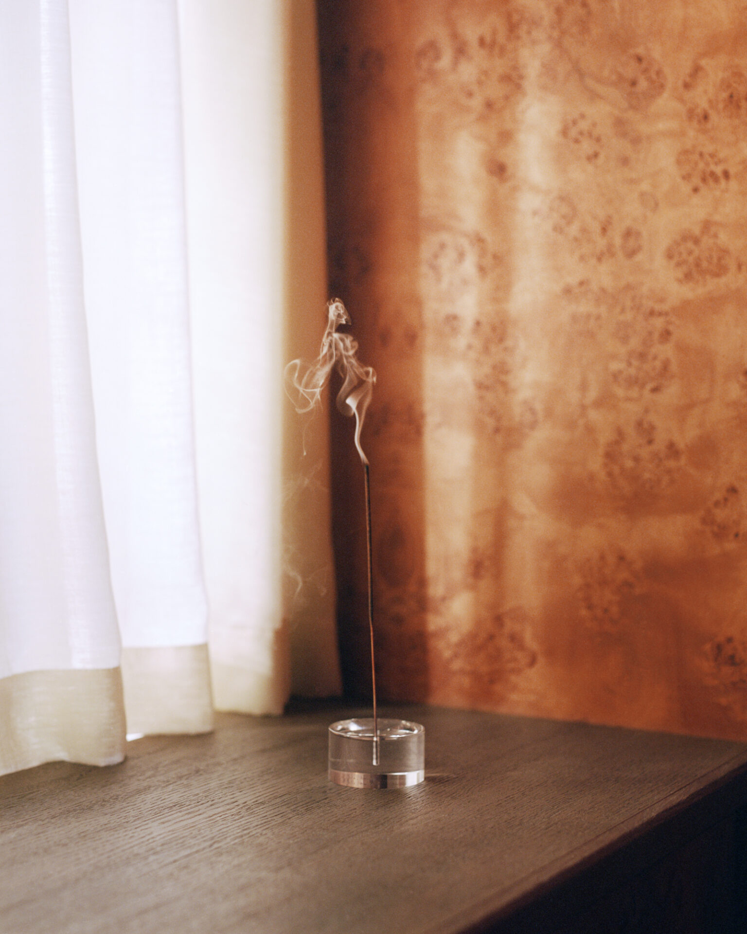 a incense stick in a glass container
