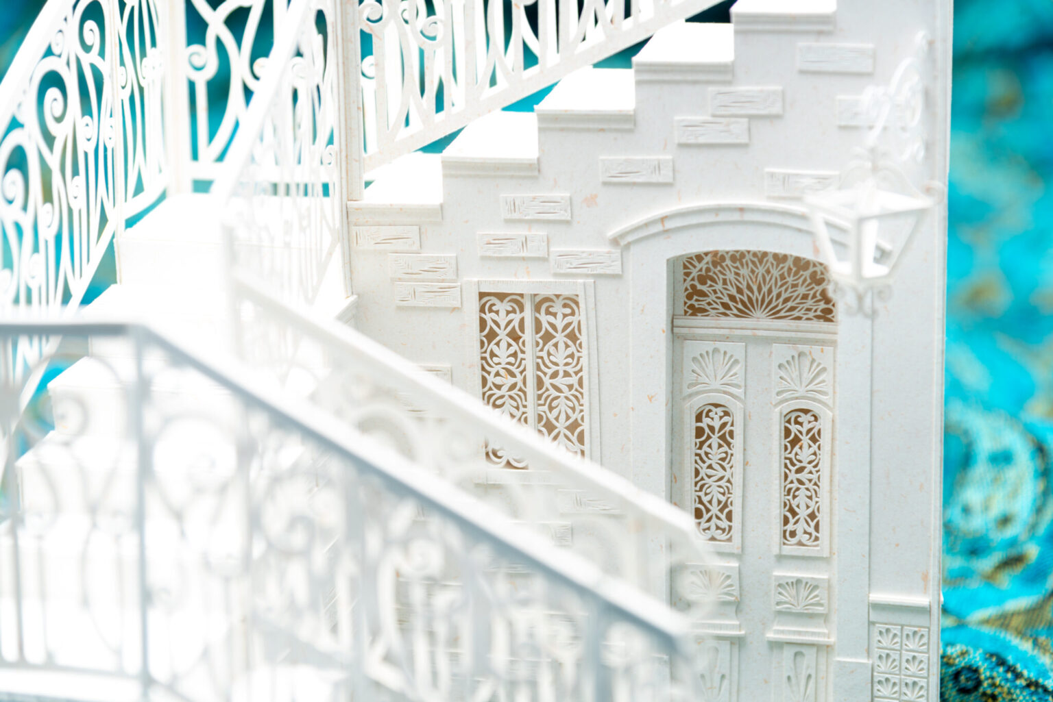 a white staircase with a door and railing