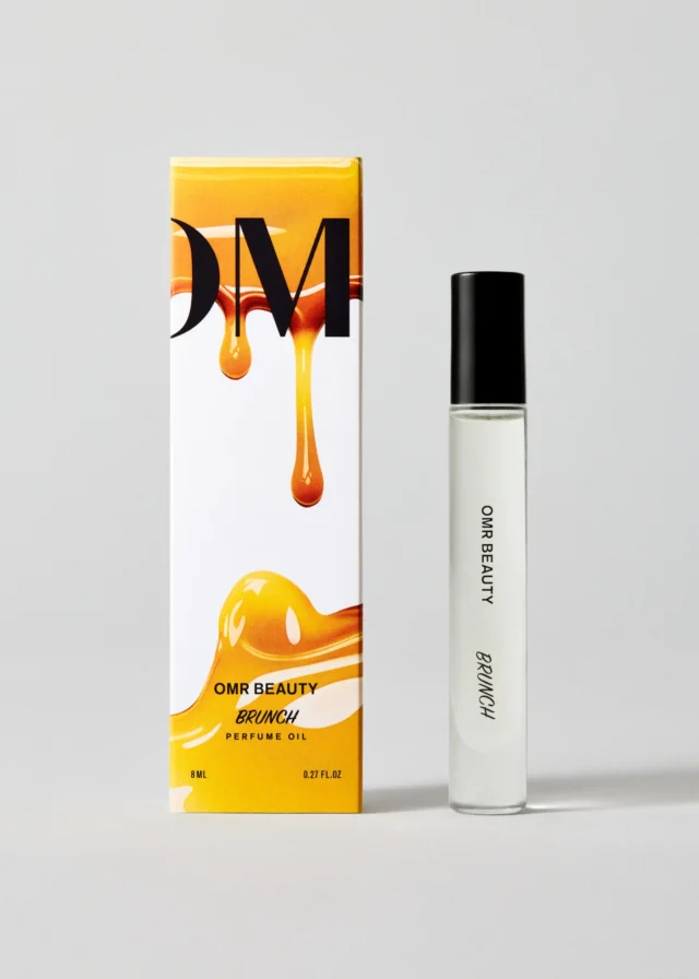 a white box with a bottle of perfume next to it