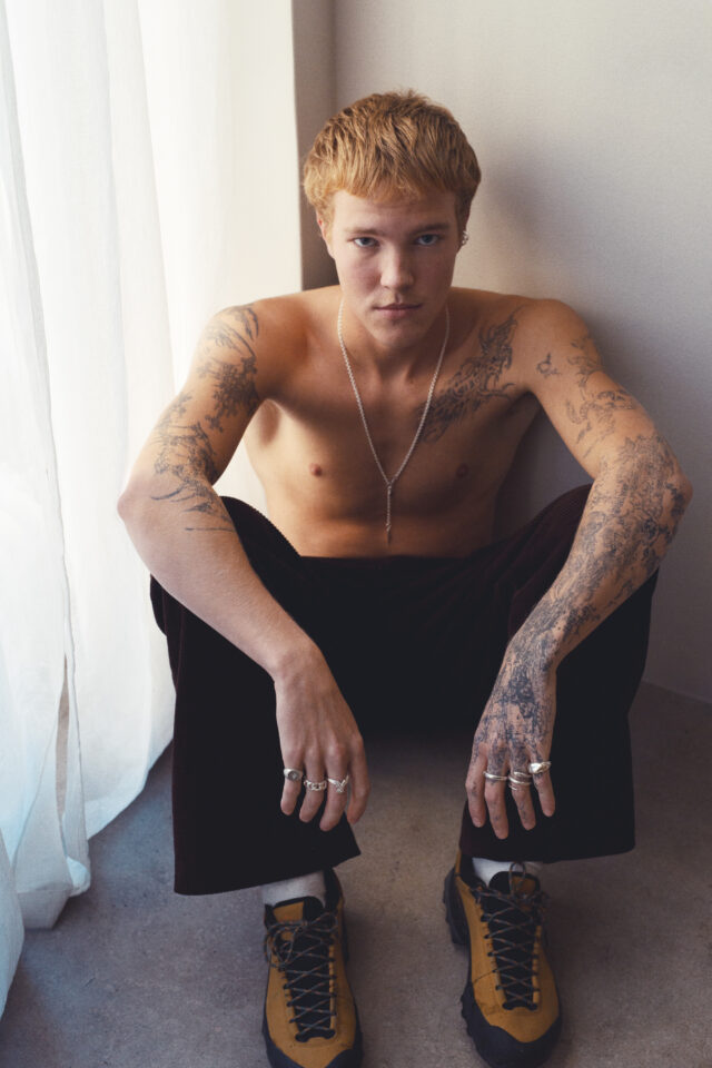 a man with tattoos on his arms