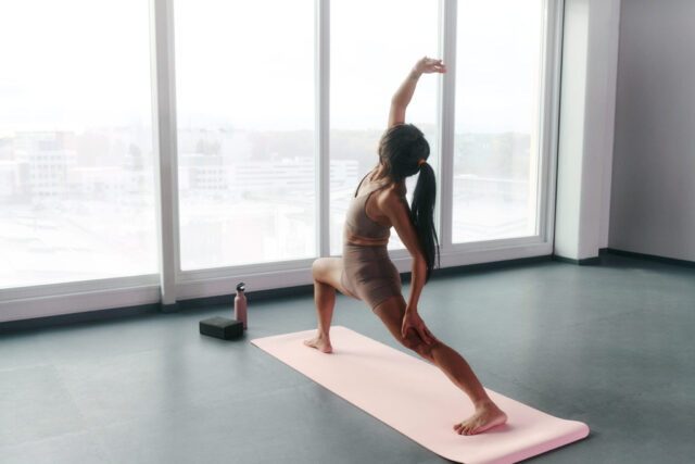 a woman stretching on a mat