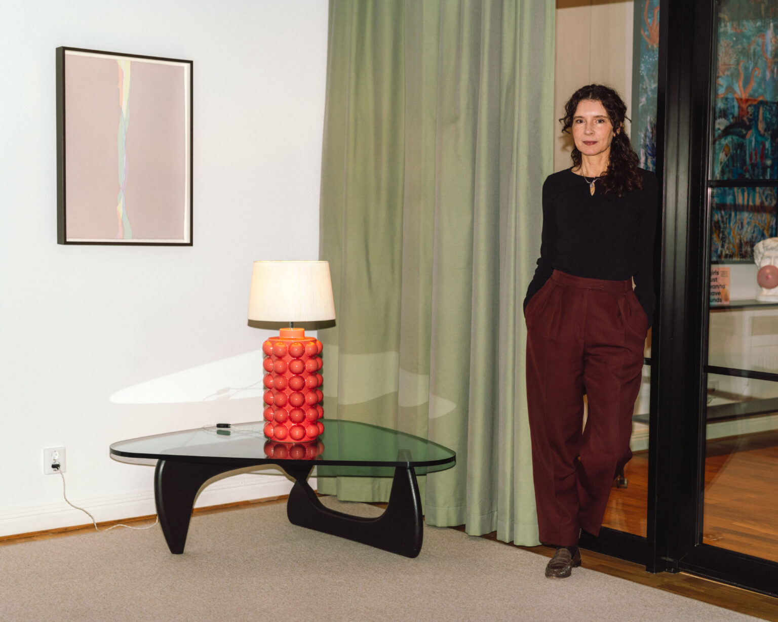 a woman standing in front of a glass door