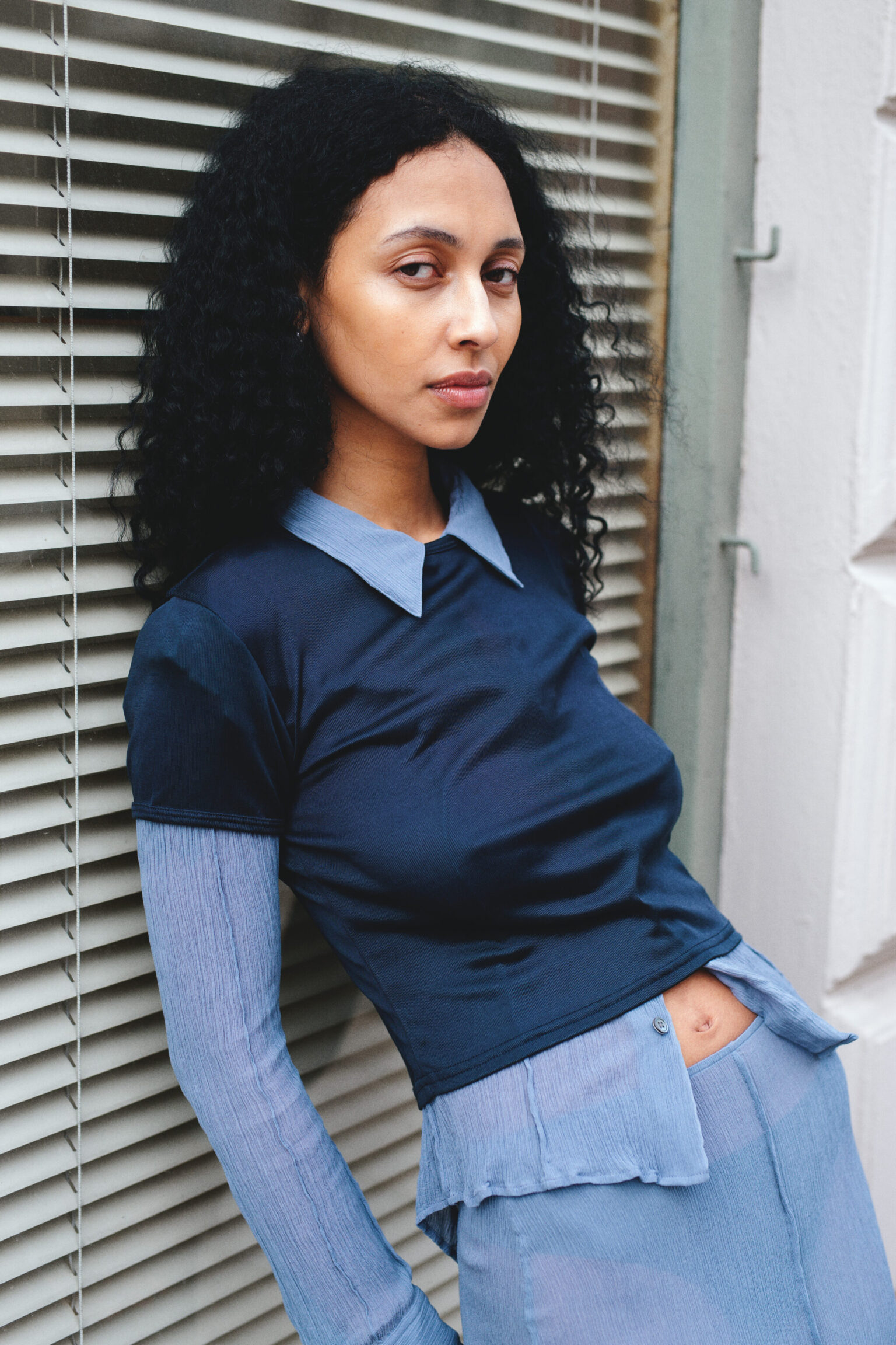 a woman leaning against a window