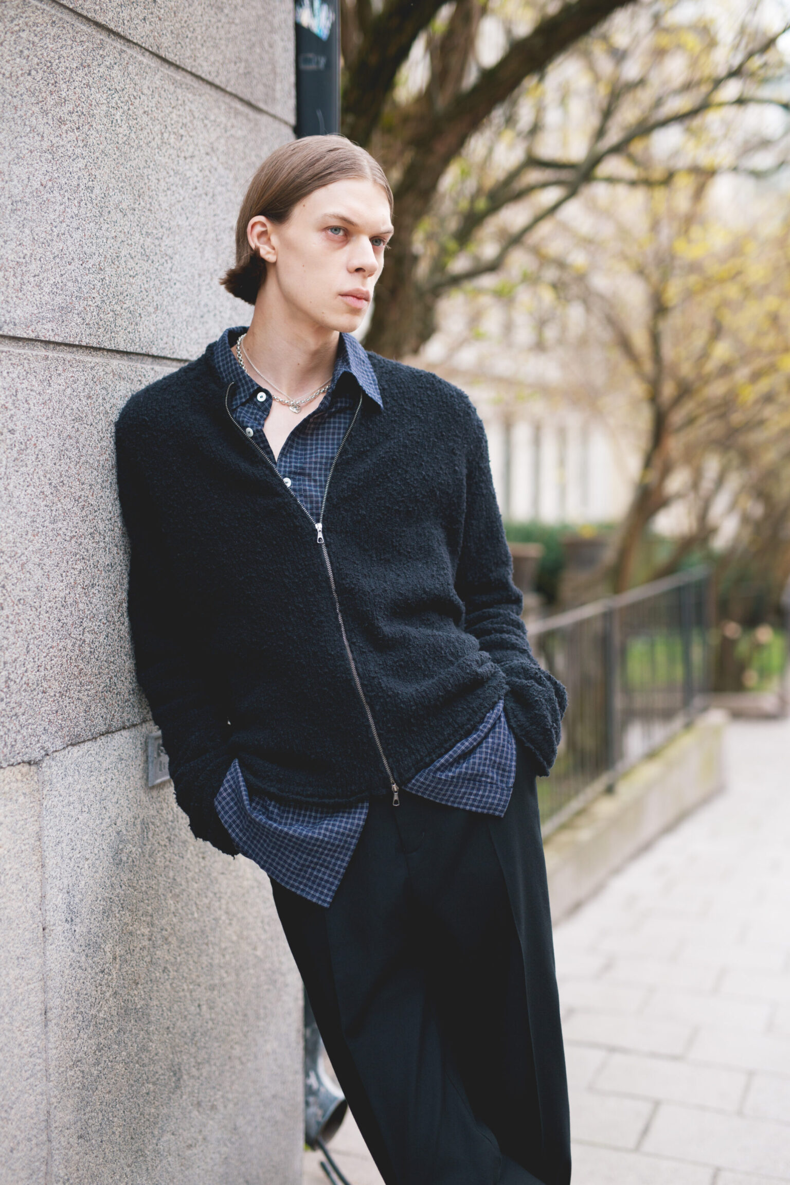 a man leaning against a wall