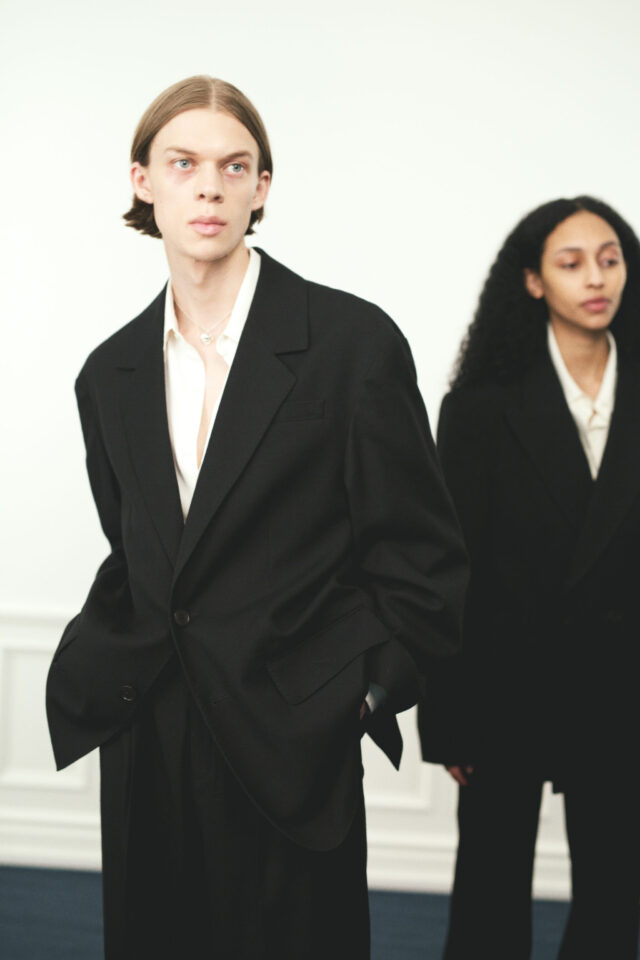 a man and woman in black suits