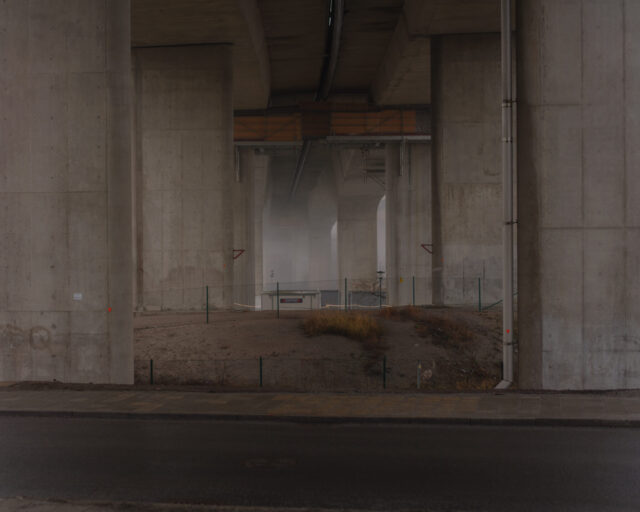 a concrete bridge with a dirt area