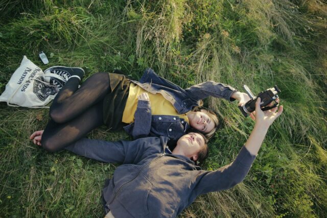 a man and woman lying in grass