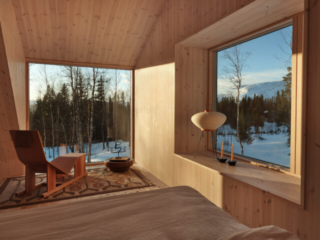 a room with a window and a bed and a chair