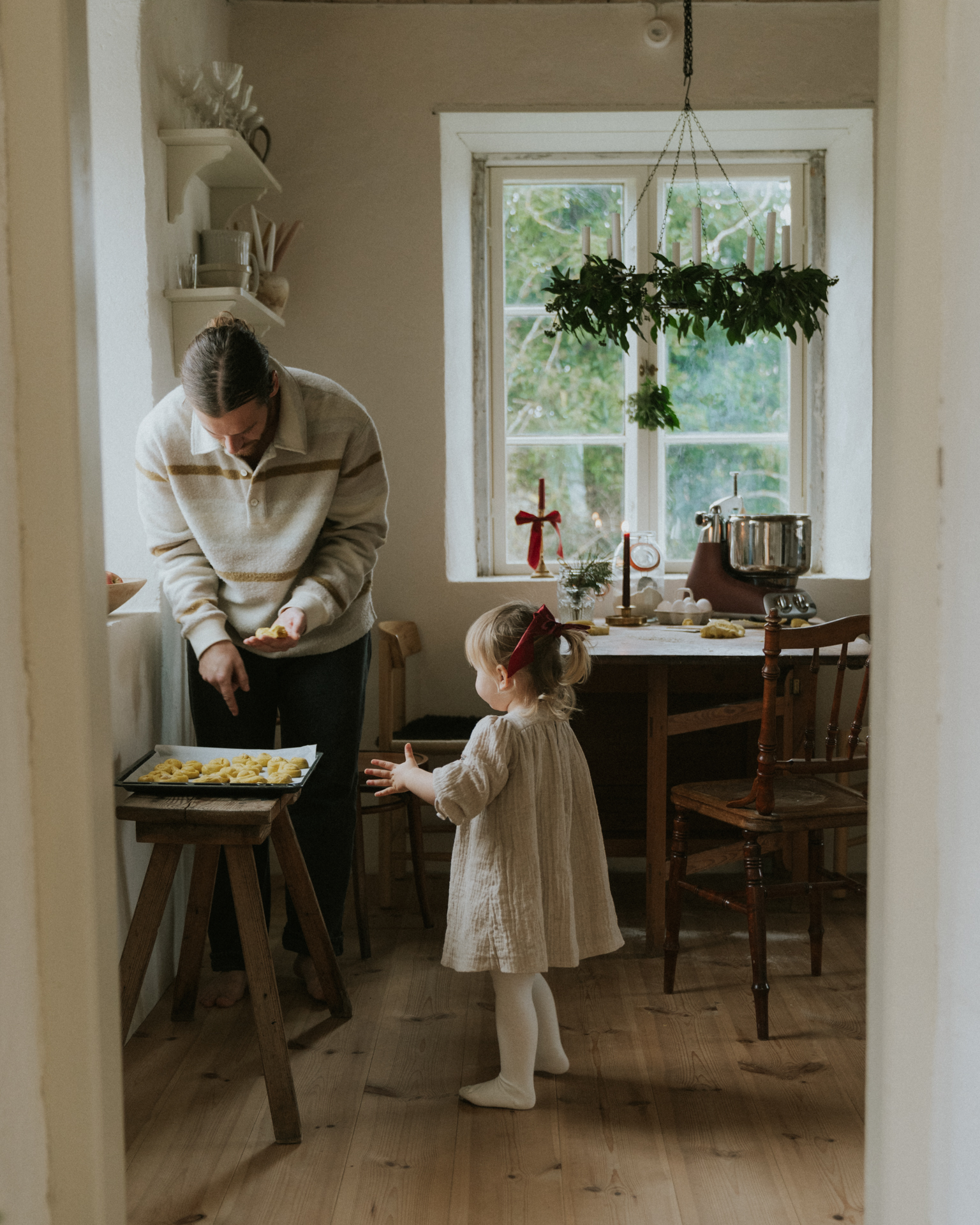 a man and a little girl standing in a kitchen