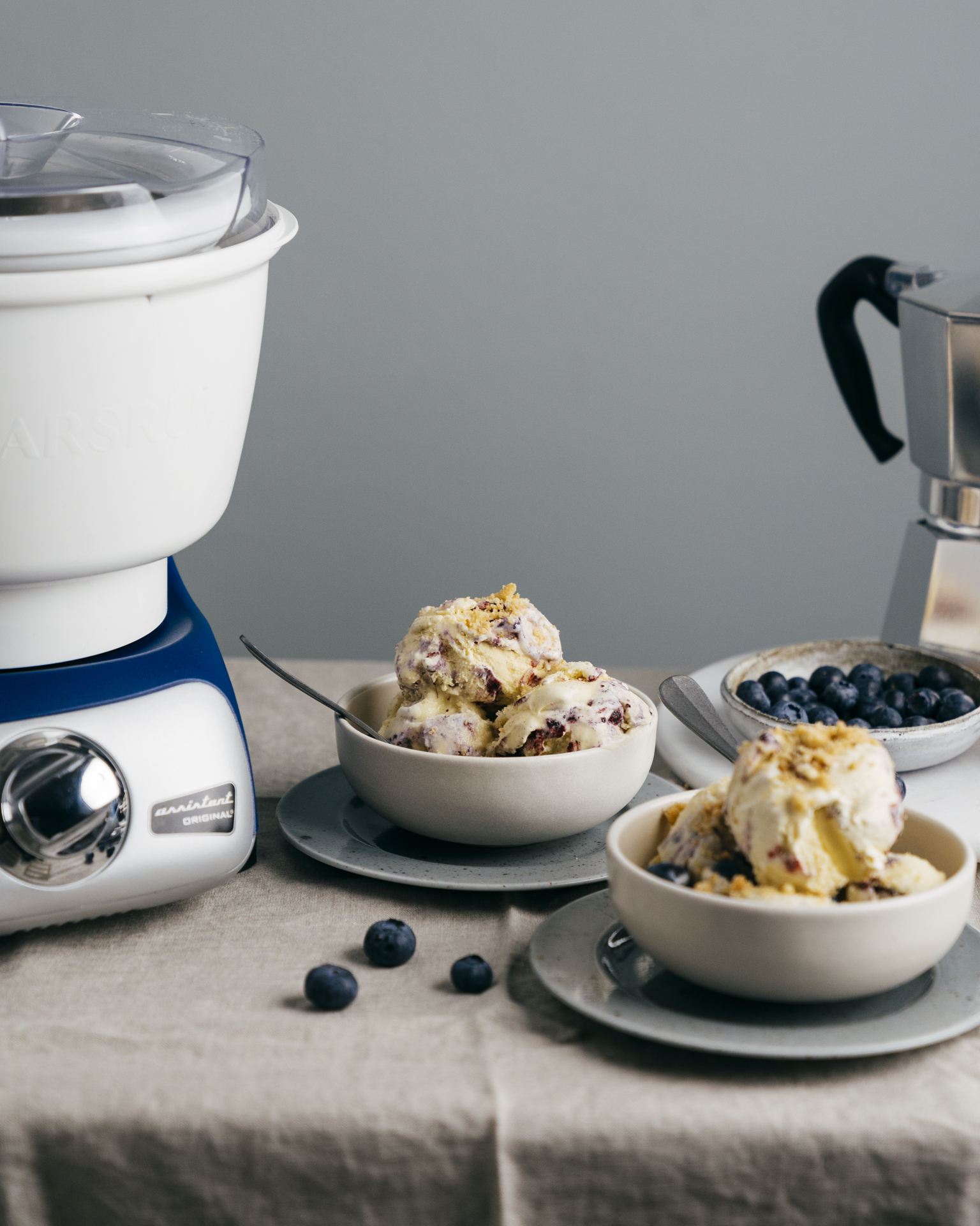 a bowl of ice cream and blueberries in bowls
