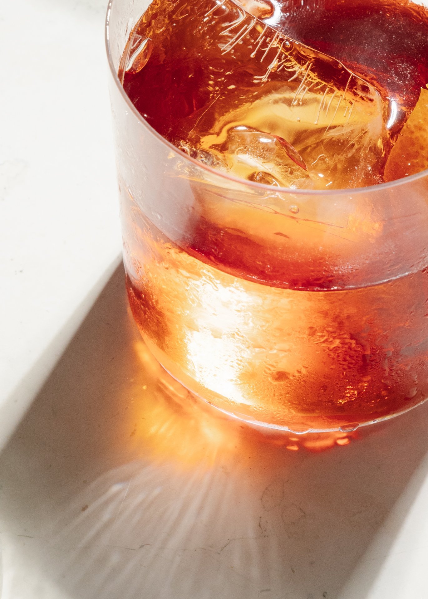 a glass of liquid with ice