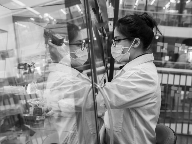 a woman wearing a mask and white coat