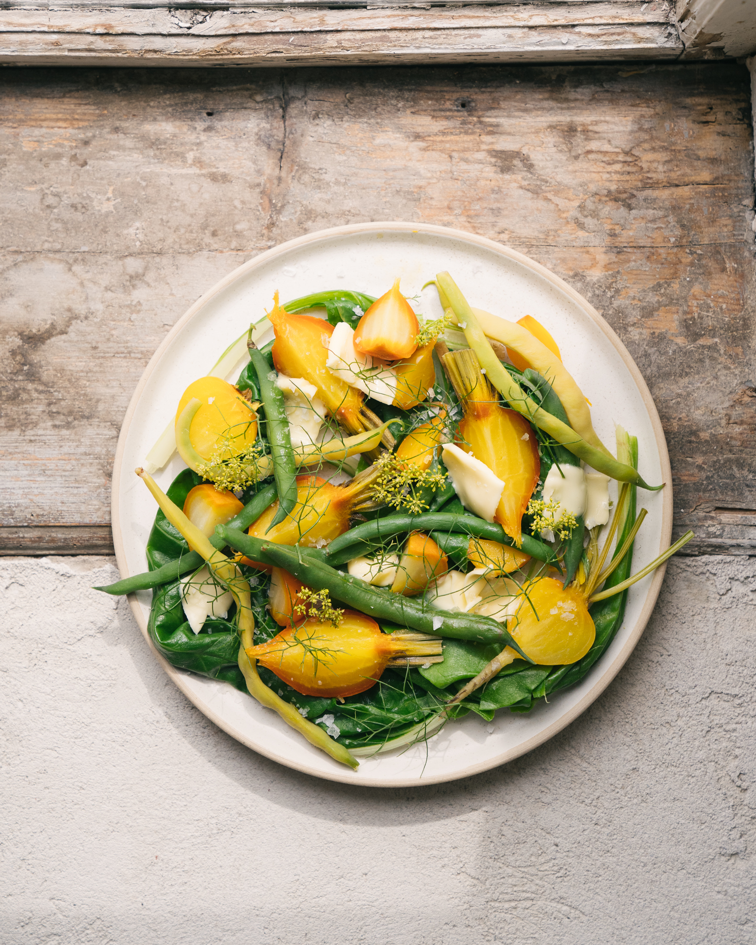a plate of vegetables on a wooden surface