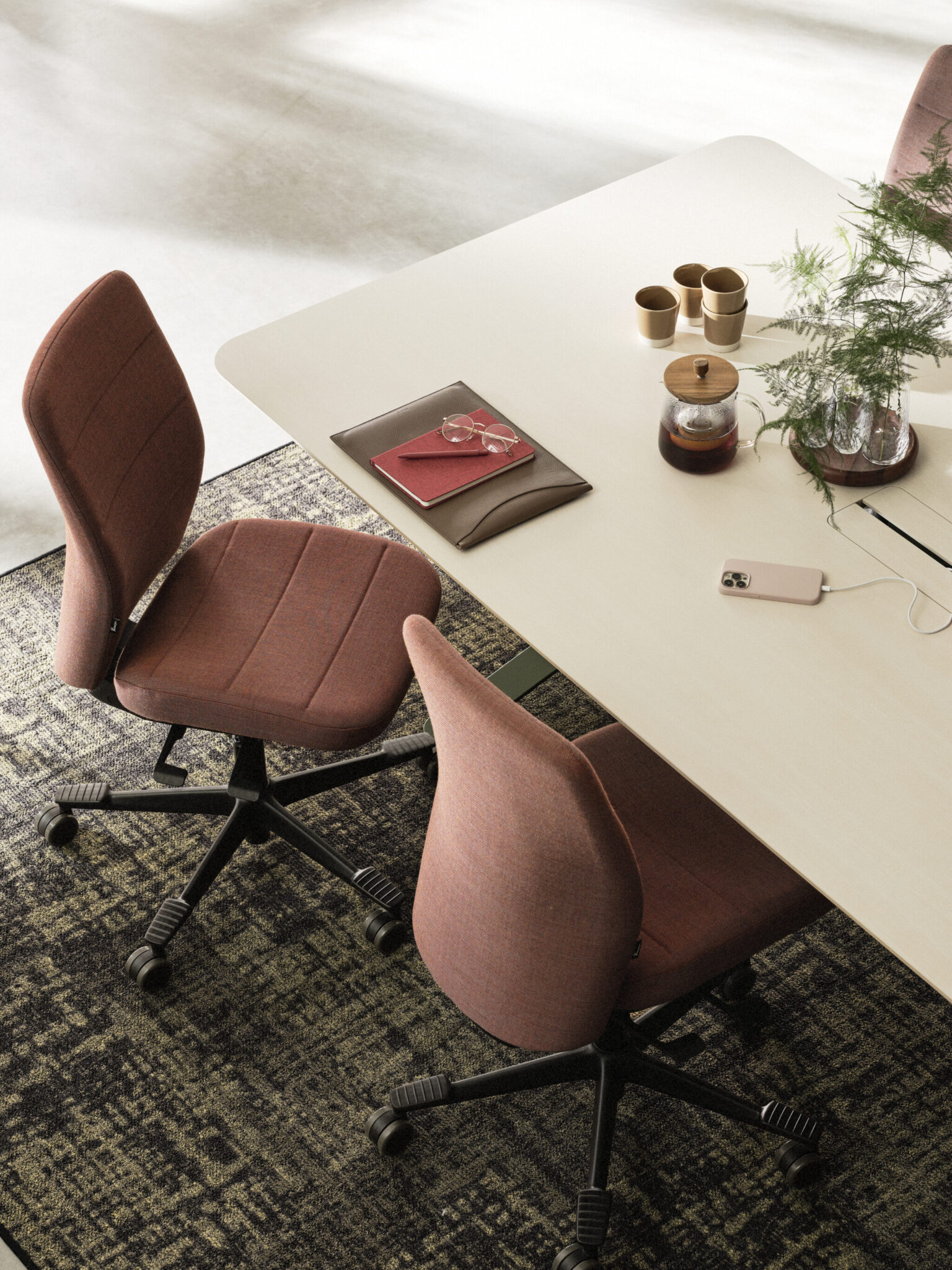 a desk with a chair and a plant on it