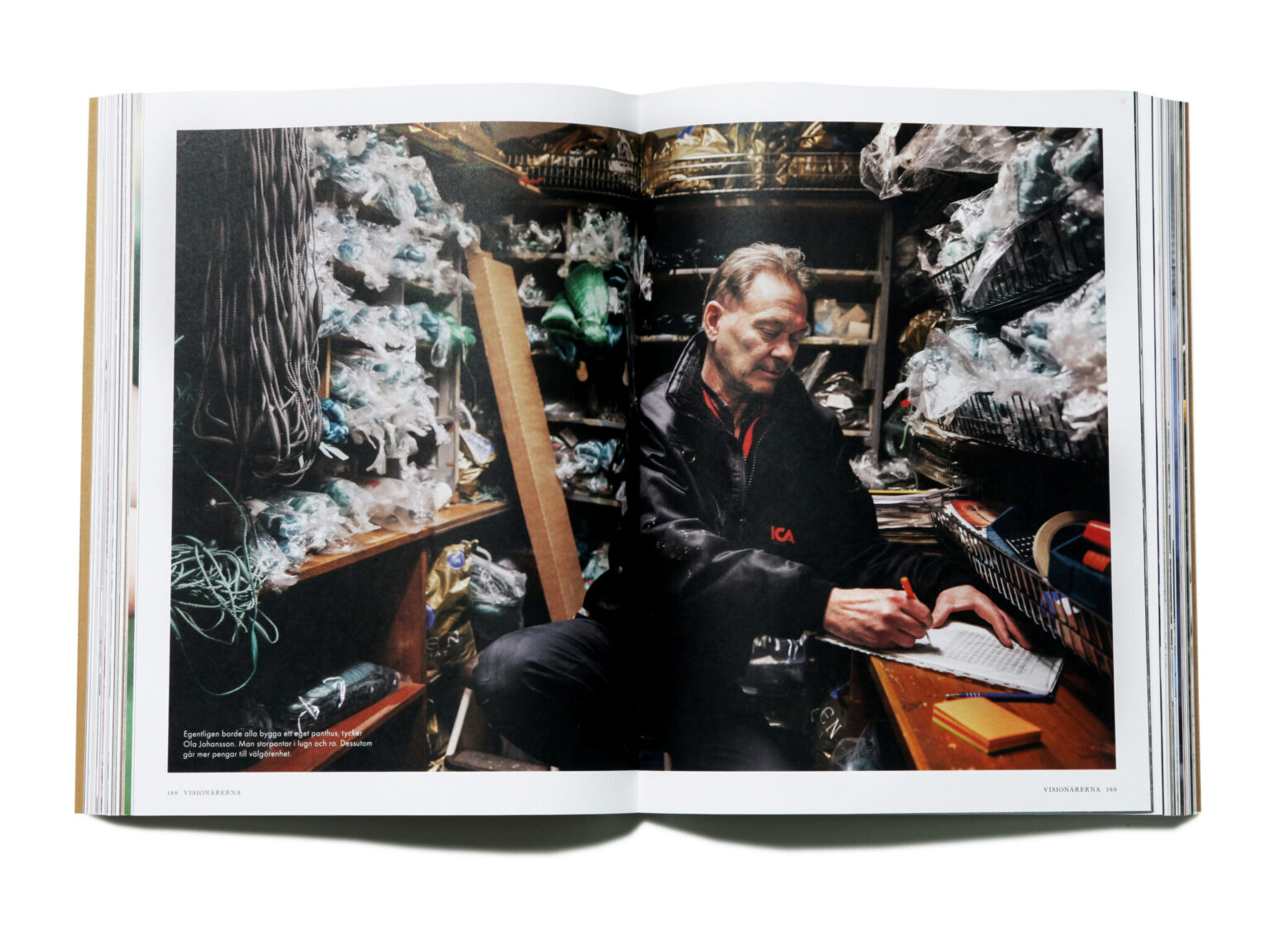 a man sitting at a desk writing on a paper